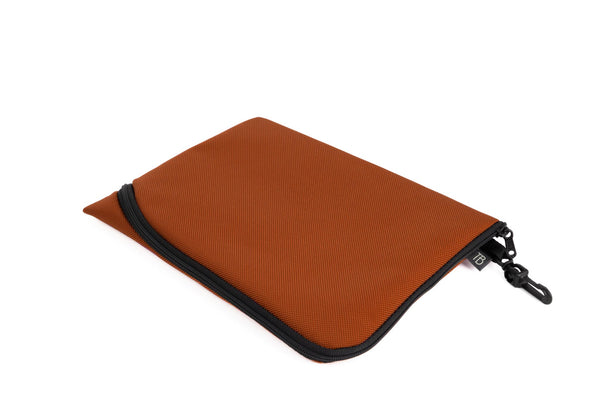 An A5 Ghost Whale Pouch in Burnt Orange (dark orange).